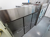 Room with stainless steel refrigerators and coolers with handles