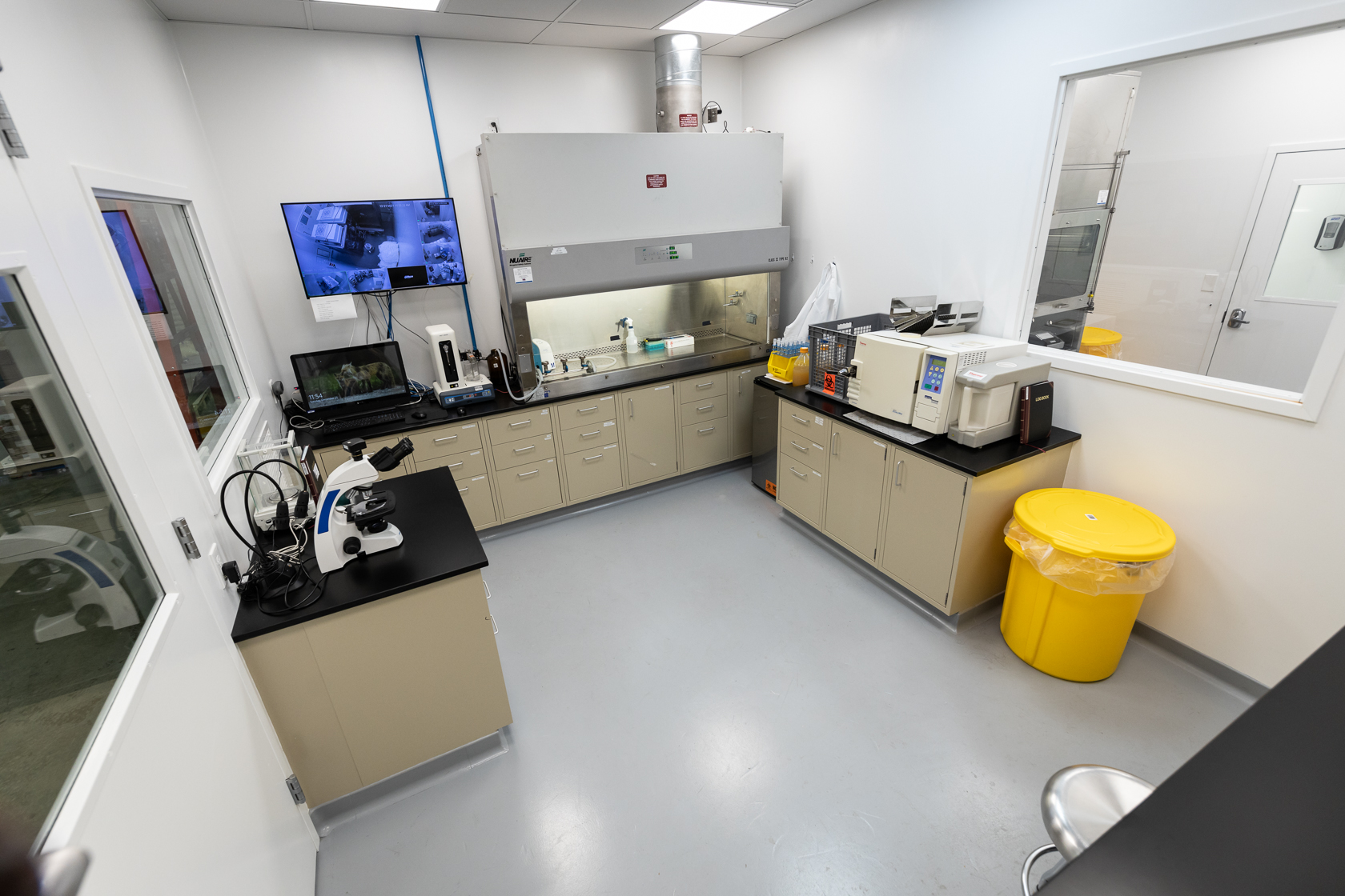 Laboratory with desk, table, and microscope.