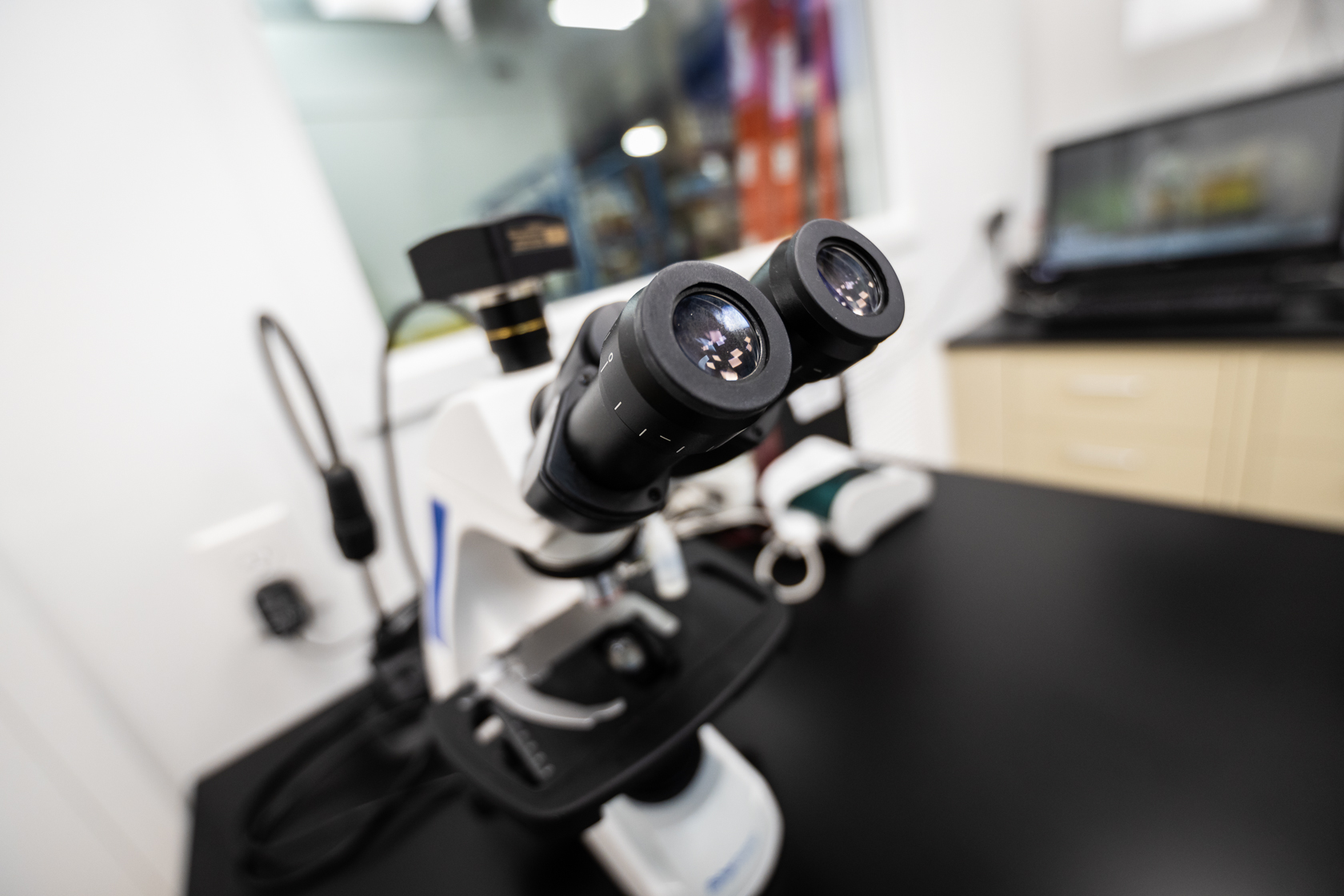 Close up of microscope resting on a table.