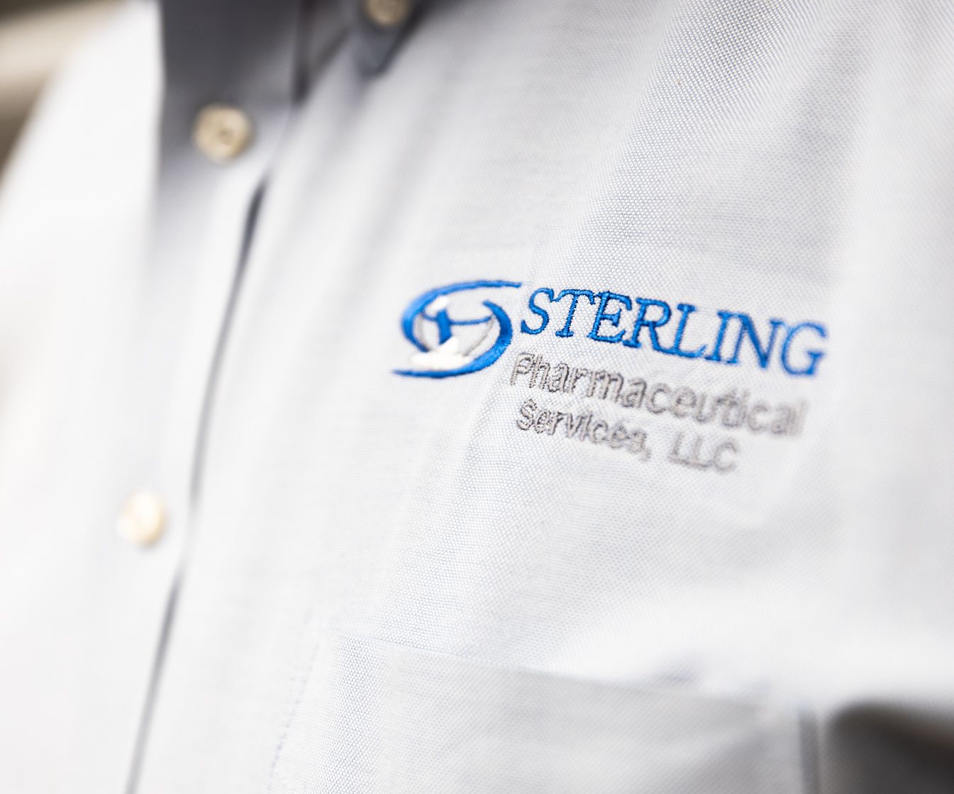 White button down shirt with Sterling Pharmaceutical written on it