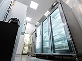 large refrigerators with glass doors full of products