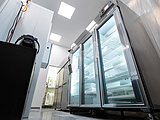 large refrigerators with glass doors full of products